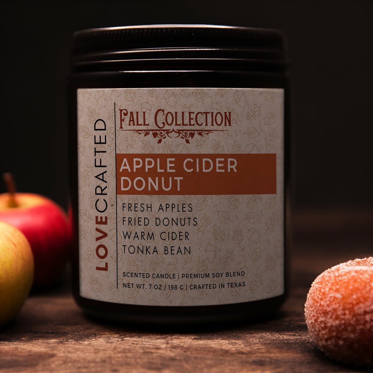 Apple Cider Donut 7oz soy blend candle in amber jar with apples and sugar-coated donuts