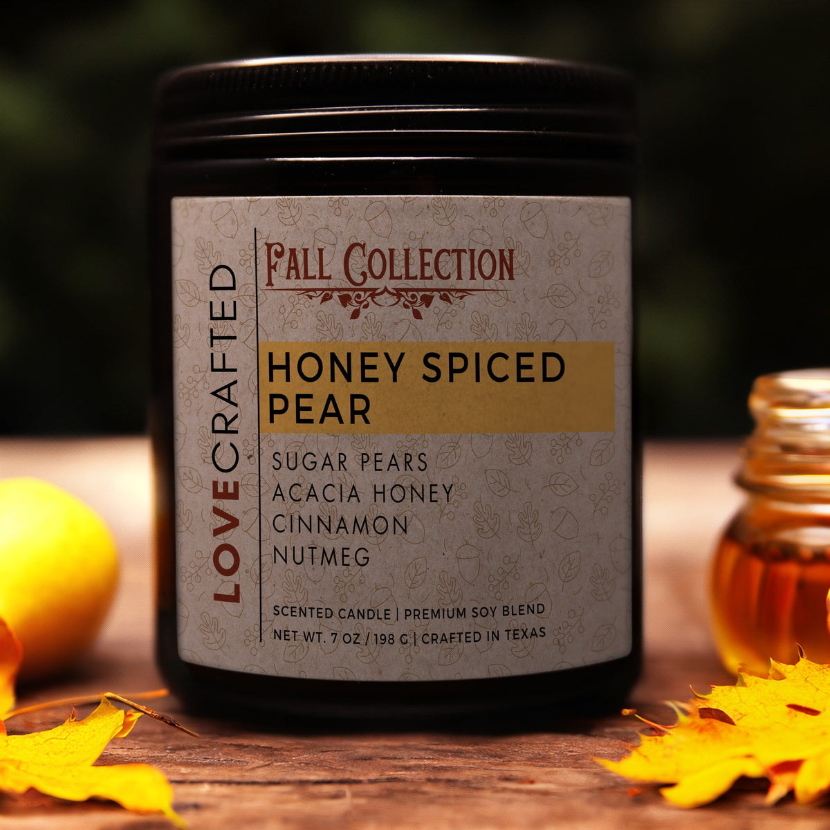 Honey Spiced Pear 7oz soy blend candle in amber jar with a pear, honey jar and fall leaves