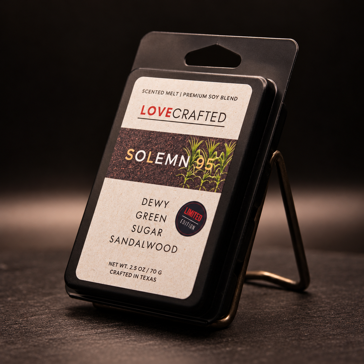 Solemn 95 soy wax melt clamshell on a display stand